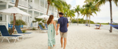 couple holding hands walking past villas at Parrot Key Hotel & Villas